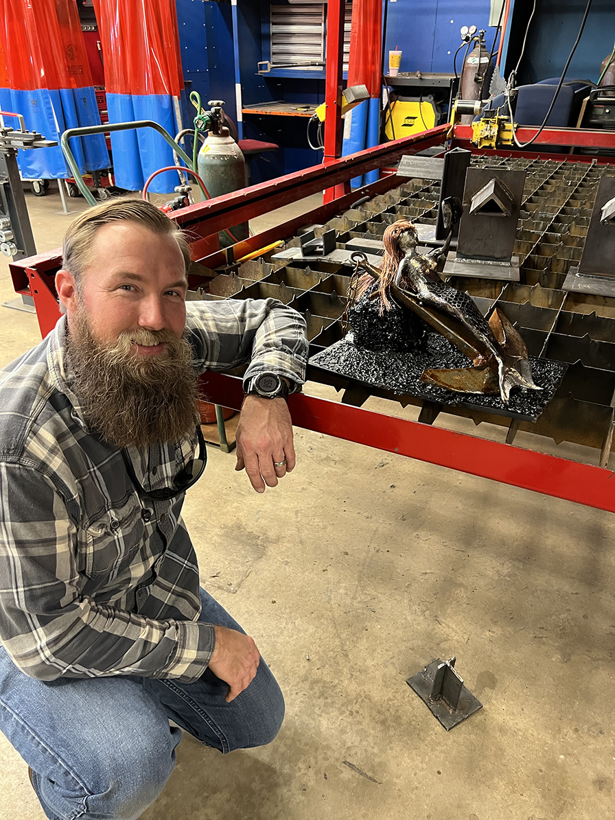 Ryan Degner pictured with Mermaid Sculpture