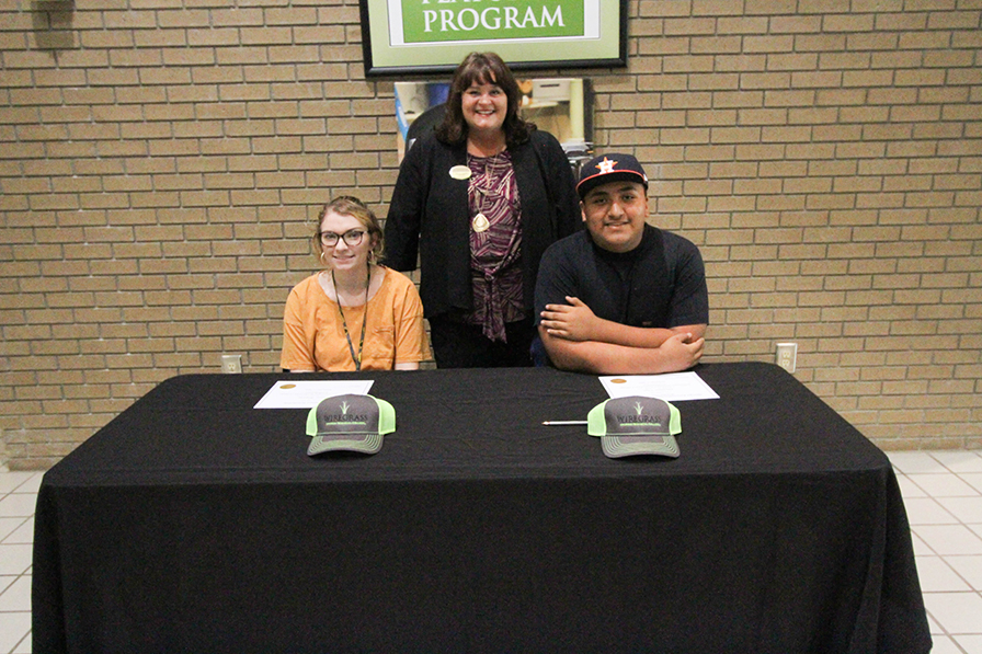Students holding scholarship awards.