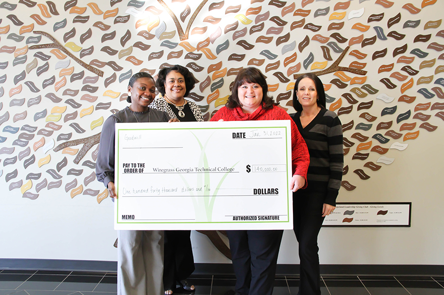 L-R: Keyara Hamilton, Goodwill Career Center Manager; Rosalind Neal, Goodwill Education and Training Manager; presents a check for $140,000 to Wiregrass President DeAnnia Clements, and Wiregrass Executive Director of Fundraising for student scholarships.