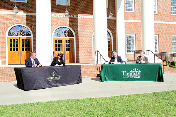 Wiregrass President Tina Anderson and Thomas University President sign agreements