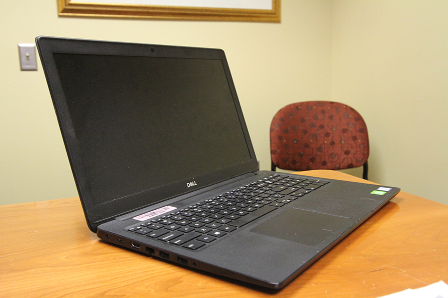 Black Laptop sitting on a desk with a black, blank screen