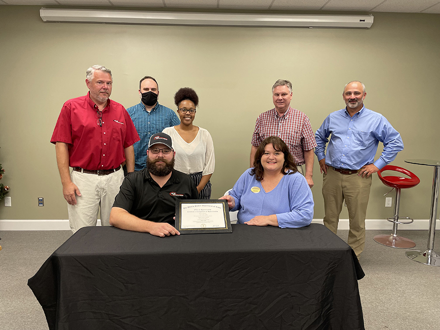 College Student Marc Hughes poses with WGTC and Ace Technologies representatives.