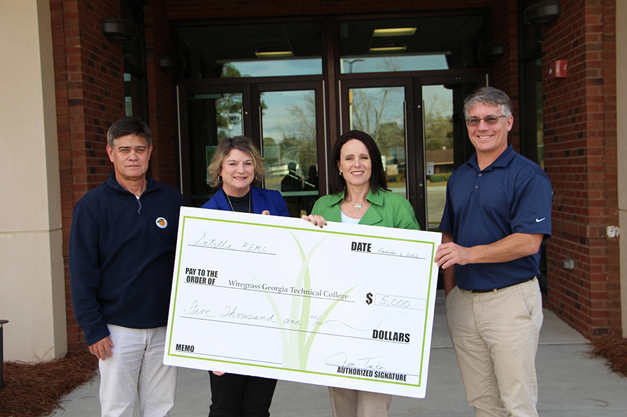 Wiregrass Satilla Donation Check Held By Staff