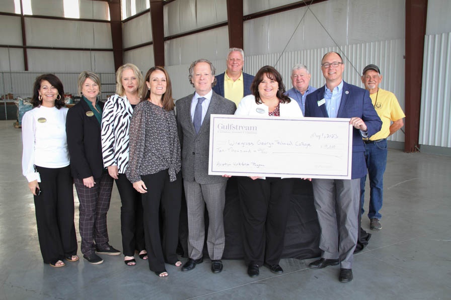 Wiregrass faculty and staff receiving donation from Gulfstream Aerospace Corp