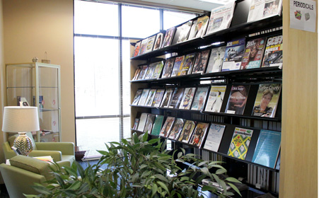 Sitting area of Coffee Campus Library next to magazine rack